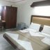 Hotel Rajmata Pvt Ltd, Hyderabad: simple guest room with bed, wardrobe, vanity desk and chair