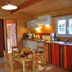 Lagrange Vacances Les Ségalières kitchen-dining area in Gramat with striped furnishings and wooden ceiling
