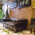 Hotel Duquesa in Seville lobby with leather sofa, black side table, plants and checkered tile floor
