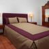 Monte Dos Apóstolos in Portalegre: bed with burgundy and beige bedding, bedside lamps, and wooden wardrobe
