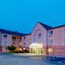 Sonesta Simply Suites Pittsburgh Airport exterior with illuminated entrance and parking lot in Pittsburgh