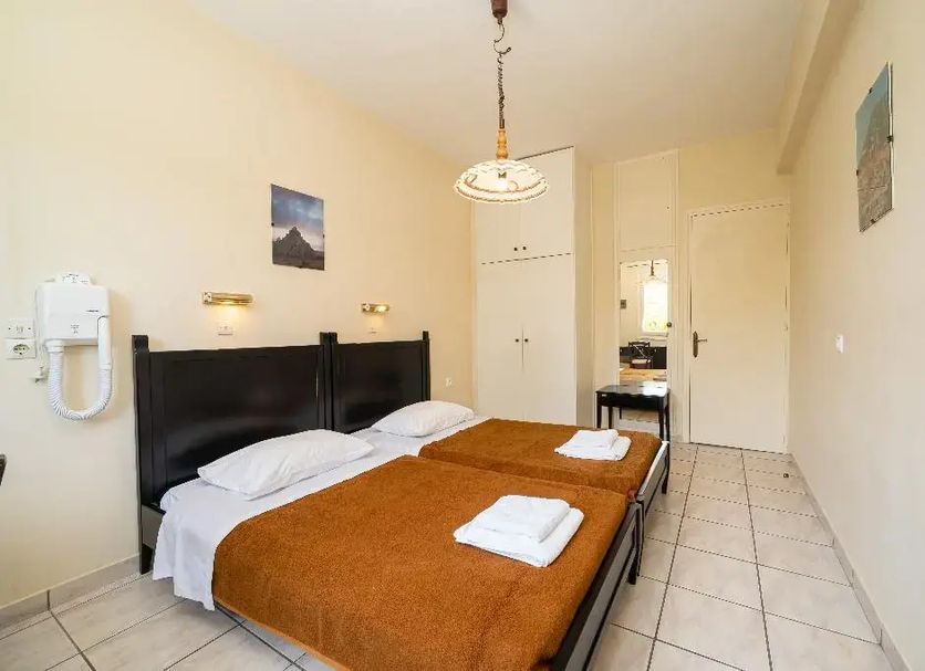 Lorenzo House Apartments in Lassi bedroom with twin beds, tiled floor and wall mirror