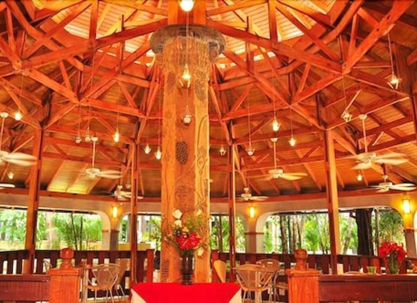 Le Plaza Hotel in Port Au Prince with a warm wood-beamed lobby and central chandelier
