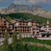 Aman Rosa Alpina in Badia/Abtei with alpine chalet-style buildings and mountain backdrop