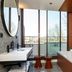 Hotel Du Port in Nogent-sur-Marne bathroom with double sinks, soaking tub and floor-to-ceiling windows