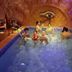 Pousada Alfa e Ômega in Alto Paraíso de Goiás with guests relaxing in an indoor pool