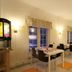 Airport Motel & Apartment in Gardermoen breakfast room with tables, chairs and serving counter