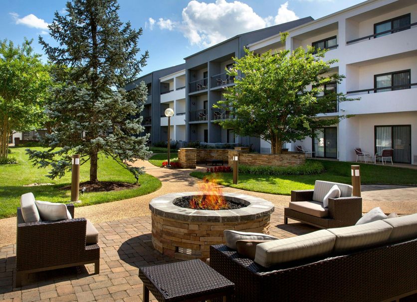 Courtyard by Marriott Dulles Airport Herndon/Reston courtyard with fire pit, seating and hotel building in Herndon