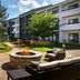 Courtyard by Marriott Dulles Airport Herndon/Reston courtyard with fire pit, seating and hotel building in Herndon