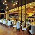 Shenyang Neu International Hotel in Shenyang restaurant with white chairs and modern dining area
