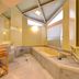 Nikko Yumoto Onsen Honokana Yado Jurin bathroom with bathtub, sink and wicker storage in Nikkō