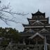 Vessel Inn Hiroshima Station in Hiroshima, with a traditional Japanese castle and overcast sky