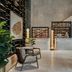 Four Seasons Hotel New Orleans lobby with reception desk, modern seating, and tall potted plants