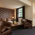 Hotel du Vin Bristol guest room with leather armchairs, sofa bed and patterned accent wall
