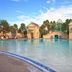 Hilton Grand Vacations Club Parc Soleil Orlando pool with palm trees and domed fountain area