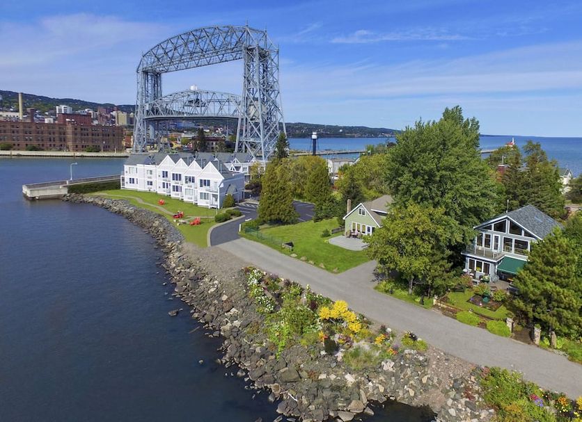 South Pier Inn in Duluth with lakeside cottages, harbor, and large lift bridge view