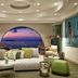 Myconian Korali Relais & Chateaux lounge in Mykonos with sea-view arch window and sunset view