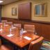 Hampton Inn & Suites Ontario conference room with wooden table and tan chairs