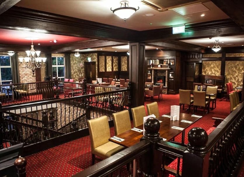 Dillons Hotel in Letterkenny with a red-carpeted restaurant lounge, chandeliers, and dining tables