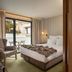 Memmo Principe Real Lisbon hotel room with balcony doors, lounge chair, bed, and city view