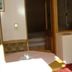 Pension Berggeist in Sölden room with TV on a small wooden stand and a bed beside a window