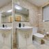 Belvilla Ilford Station Hotel bathroom with bathtub, sink, toilet, and wall mirror in Ilford