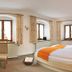 Gästehaus Enzianhof Hotel Garni in Oberammergau bedroom with double bed and three windows