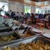 Hotel Plaza Palenque buffet dining room in Palenque with guests seated at wooden tables