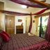 Mt Cotton Retreat in Mount Cotton bedroom with four-poster bed and private balcony view