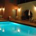 Vecchio Hotel in Rethymno with illuminated outdoor pool and patio seating at night