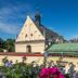 Unikat Guest Rooms Krakow view of historic rooftops and a church tower under a blue sky