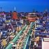 Oakhostel Zen in Tokyo with city skyline view and illuminated temple rooftops at dusk