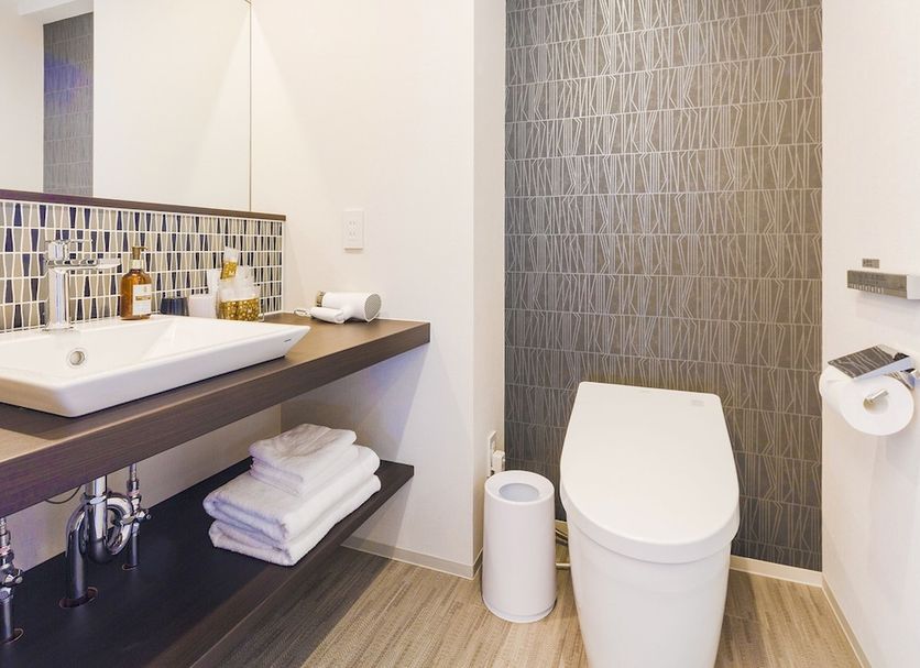 Hotel M's Est Shijo Karasuma Kyoto bathroom with sink, toilet, and patterned tile wall