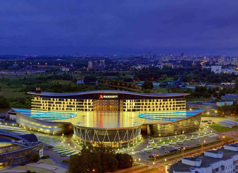 Minsk Marriott Hotel in Minsk with illuminated exterior and city skyline at dusk