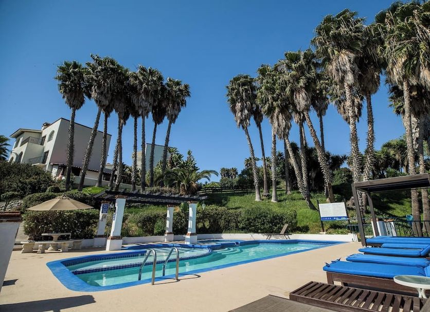 Real del Mar Golf Resort in Tijuana with outdoor pool, blue loungers and palm trees