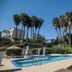 Real del Mar Golf Resort in Tijuana with outdoor pool, blue loungers and palm trees