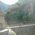 Suspension bridge over a canyon at Albergue Rural Cal Picarol in Àger, surrounded by rocky cliffs and trees