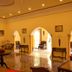 Raj Palace Resort in Sawāi Madhopur, elegant lobby with arches, marble floor, and seating area