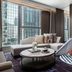 The St. Regis Hong Kong lounge with city-view windows and a children's teepee beside a round coffee table.