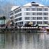 Welcome Hotel at Srinagar waterfront hotel with mountain backdrop and lake reflections in Srinagar