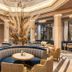BLESS Hotel Madrid lounge with curved seating, tall floral centerpiece and chandelier in elegant interior