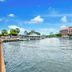 Quayside Hotel, Malacca waterfront view with river, boats, and hotel buildings under blue sky