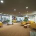 Hotel Noreg Ålesund lobby with yellow seating, potted plants and large windows