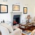 Casa Brenna Tosatto Art Experience in Lenno: elegant lounge with fireplace, armchairs, and glass coffee table