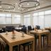 Hilton Garden Inn Richmond South/Southpark dining area with wooden tables and dark chairs in Colonial Heights