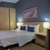 Hotel Santiago, Praia: compact hotel room with double bed, bedside tables, wall TV, and air conditioner