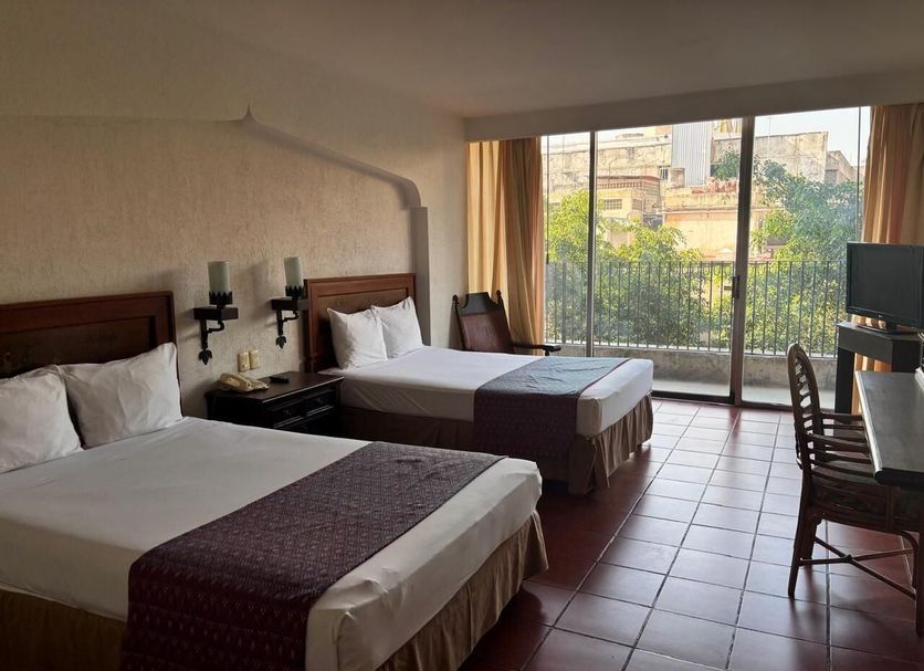Hotel Fenix in Guadalajara guest room with two beds and balcony city view