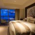 Chalet Ivy Hirafu, Niseko guest room with king bed and balcony view of snowy trees in Kutchan
