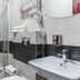 Royal Gdansk bathroom with glass shower, sink, wall hair dryer and towel rack in Gdansk
