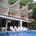 Hotel Coco Beach in Manuel Antonio with outdoor pool, lounge chairs, and tropical hillside setting